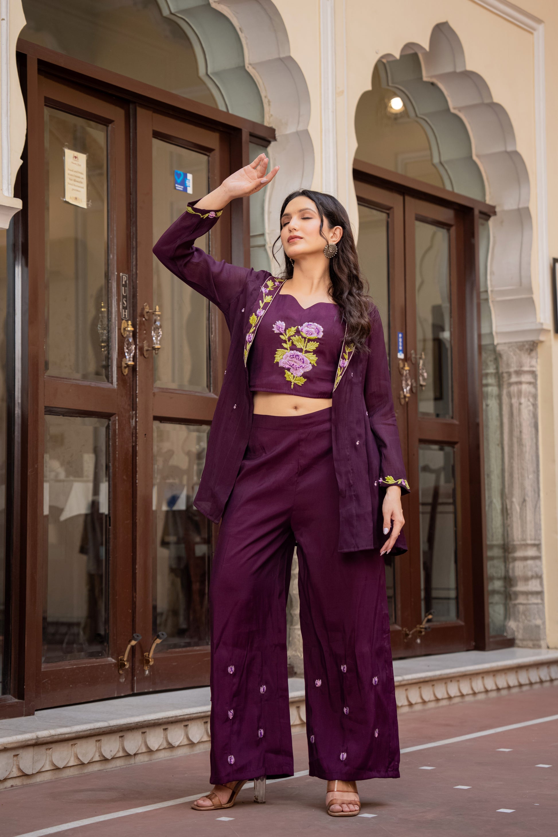 Stylish woman in a purple kurta and palazzo set featuring floral designs, representing graceful festive wear for women