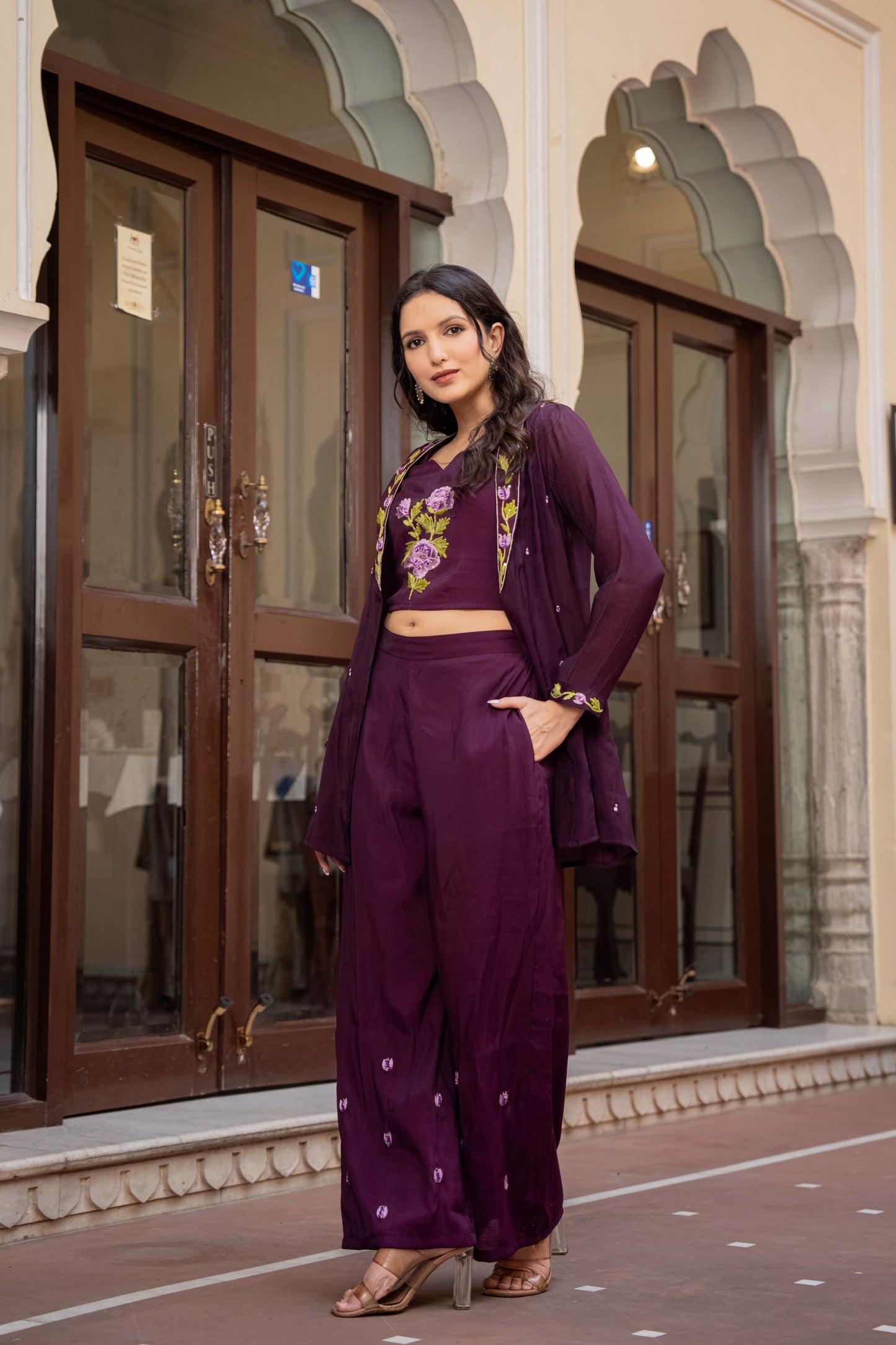 woman wearing a floral purple kurta palazzo set, captured indoors as part of modern ethnic sets for women