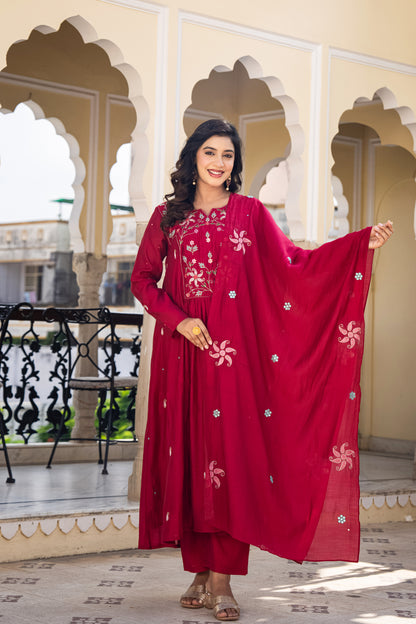 Woman in a red Kurta set designed for wedding standing on a balcony.