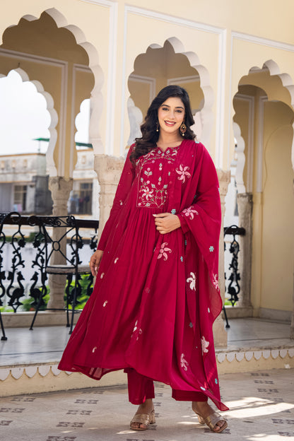 Woman in a red traditional outfit standing in an architectural setting