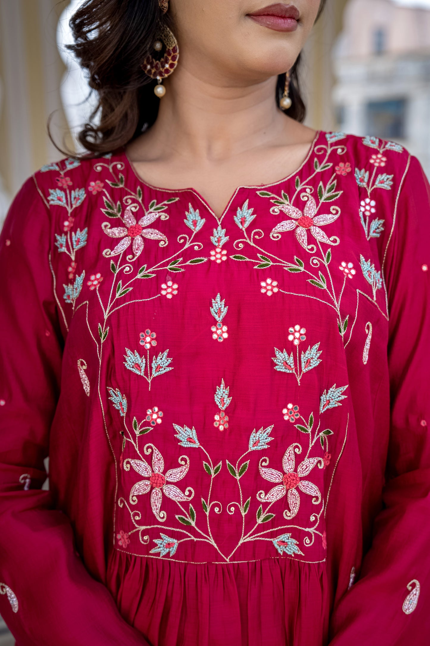 Red embroidered traditional outfit with floral patterns