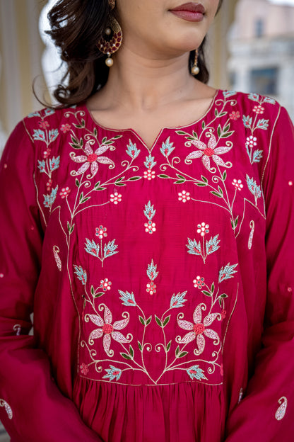 Red embroidered traditional outfit with floral patterns