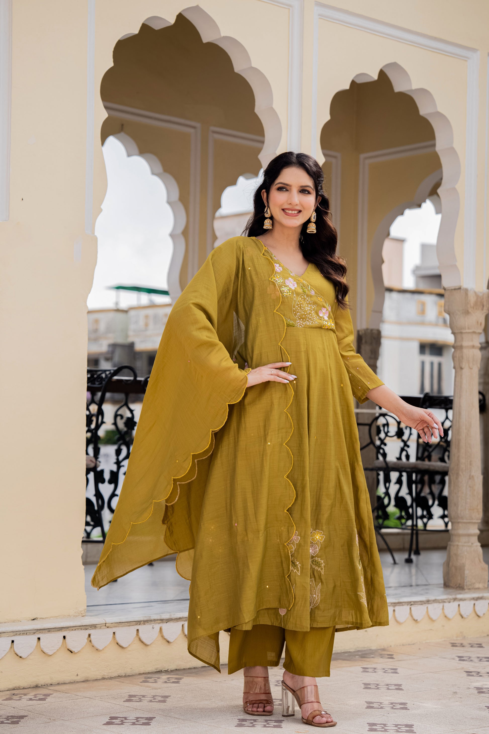 Elegant green kurta set worn by a woman outdoors, highlighting festive kurta sets for women.