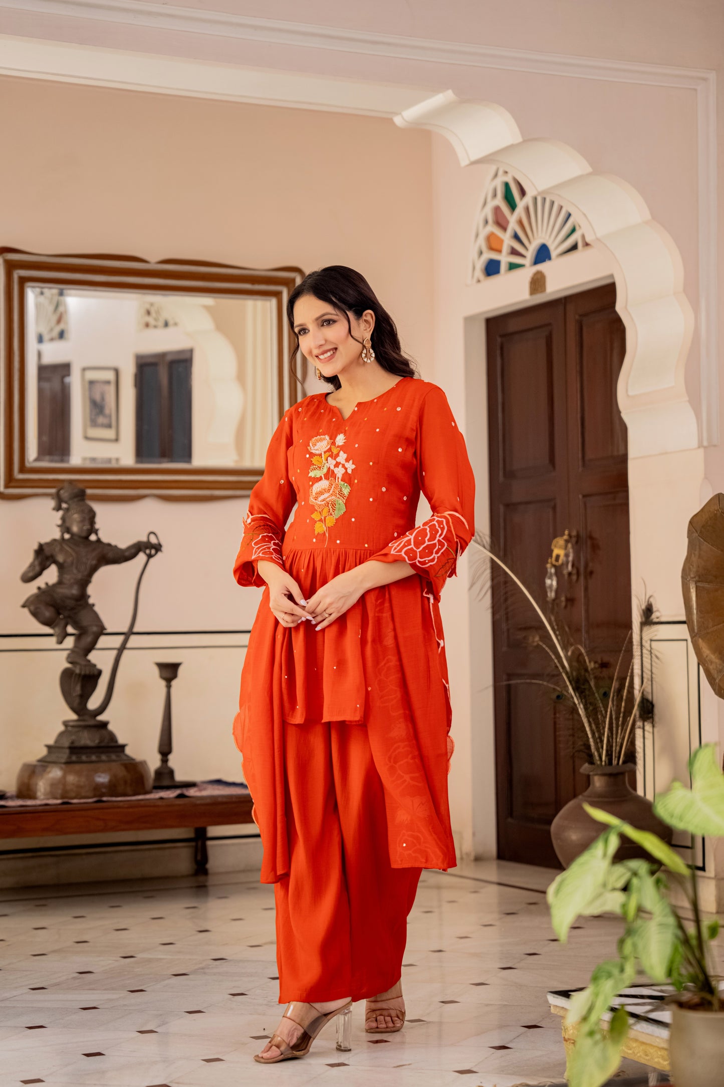 orange traditional kurta pant set for women worn by a woman, representing stylish ethnic set.