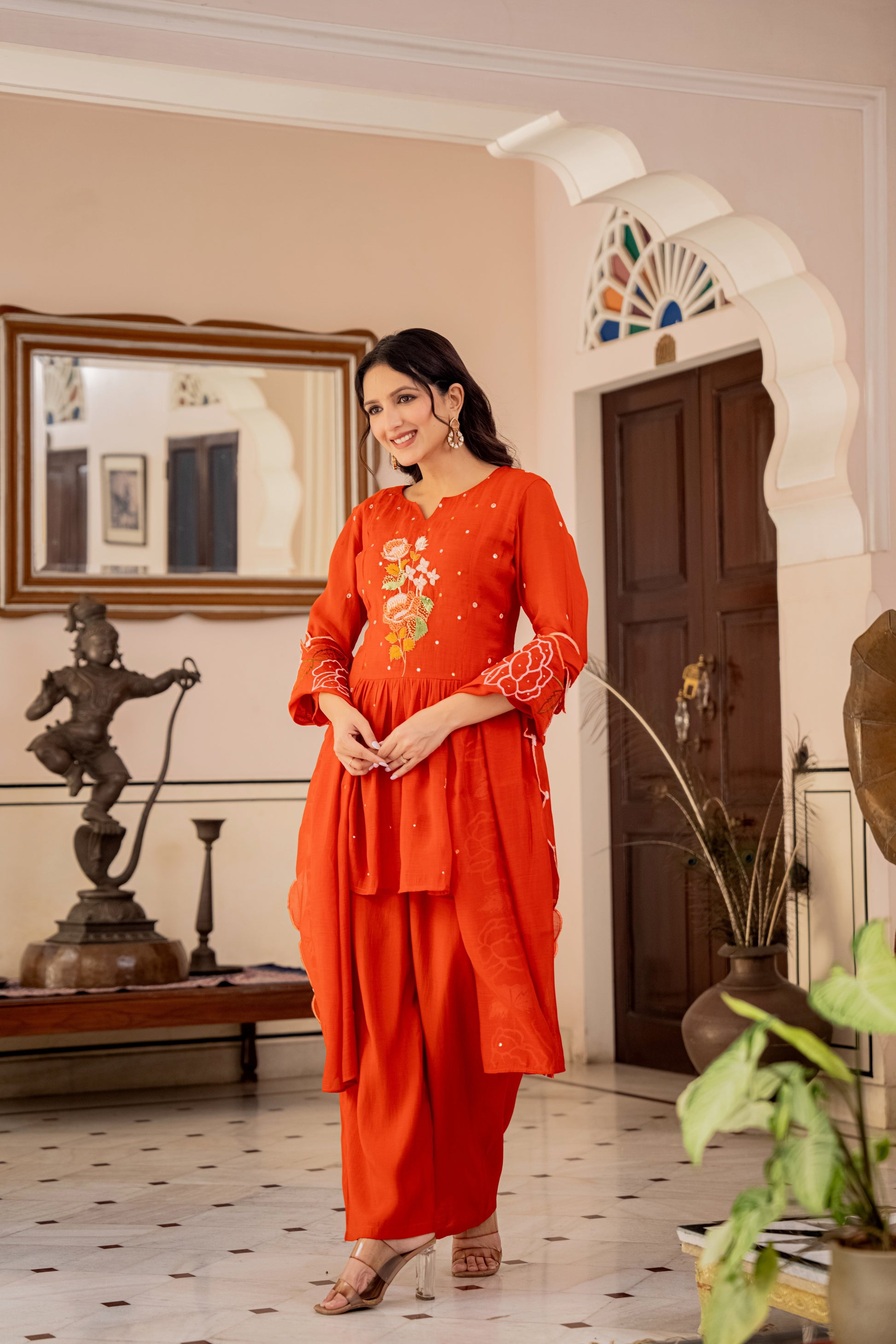 orange traditional kurta pant set for women worn by a woman, representing stylish ethnic set.
